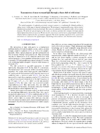 Transmission of Near-Resonant Light Through a Dense Slab of Cold Atoms